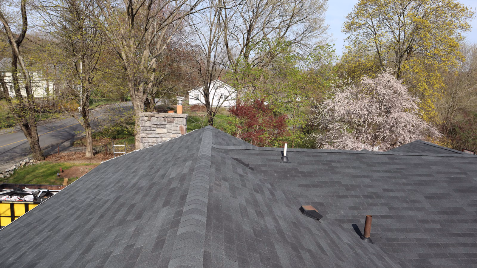 New roof next to a stone chimney