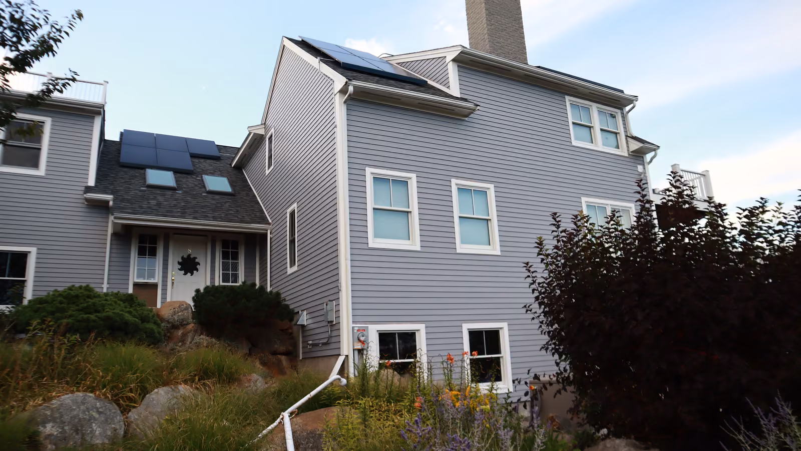 Side garden view of a Rockport home with new lap siding and corner trim