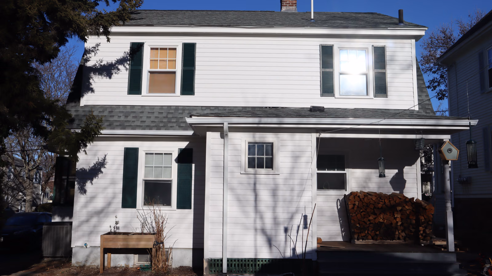 White lap siding with green shutters